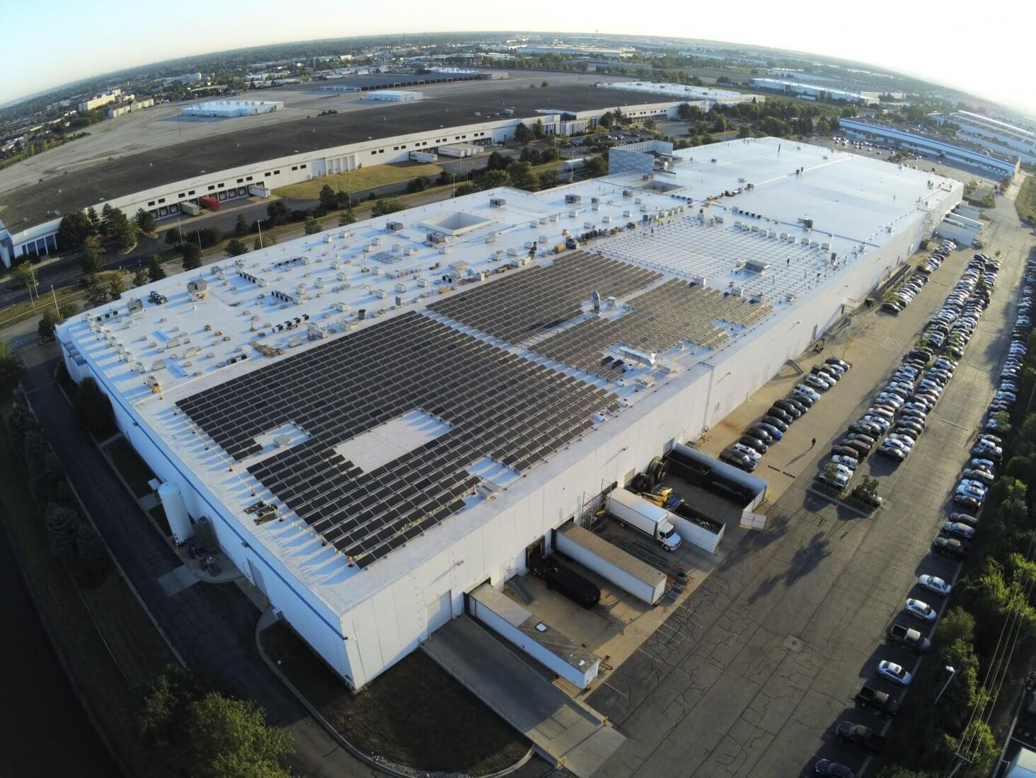 Half of a roof filled with solar panels and boxes