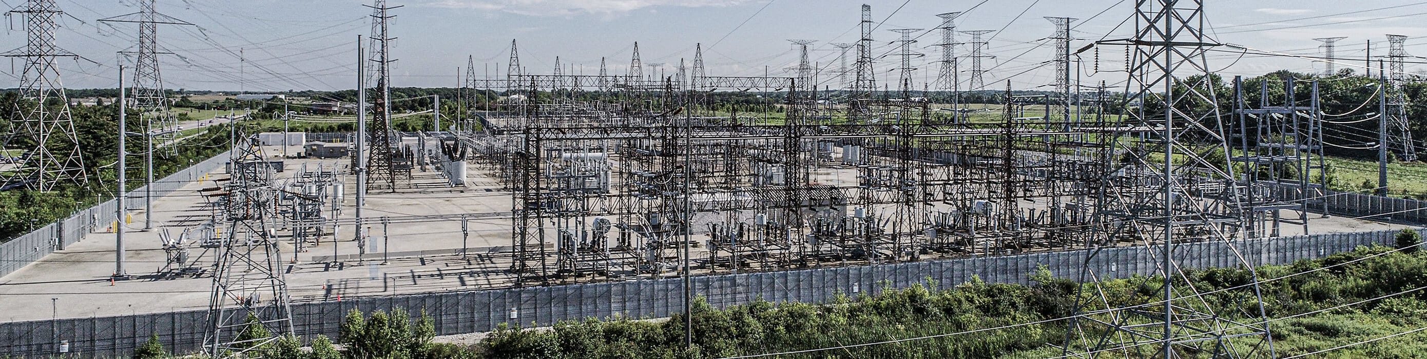 A large substation with electric wires above it.