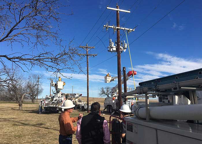 Utility workers in a boom truck.