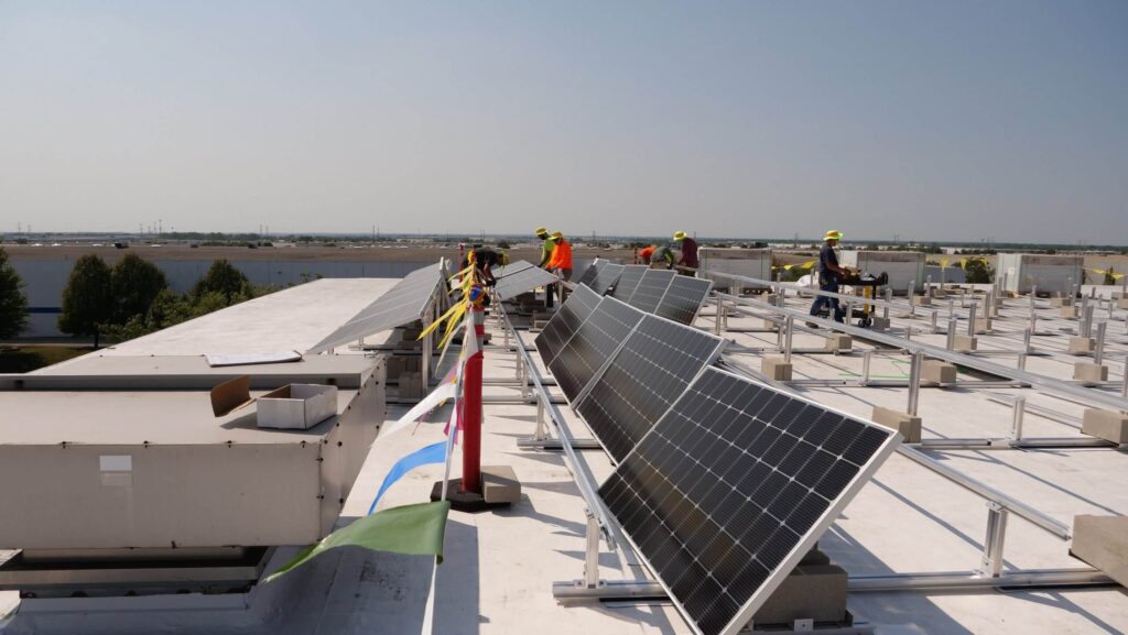 Solar panels on a roof with workers