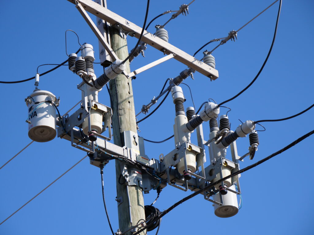 Pole-mounted automatic circuit recloser on utility pole for power grid protection